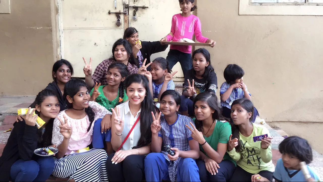 Aanchal Vash with Reach Out Together volunteers and children at a charity drive in 2017